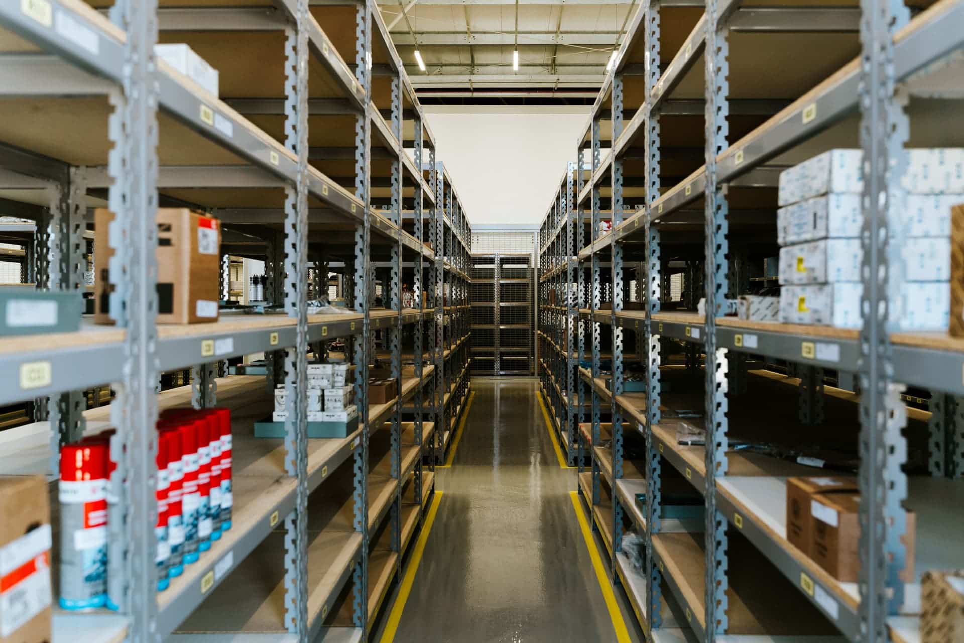 Shelved stockroom of a small business stacked with cardboard boxes ready for dispatch