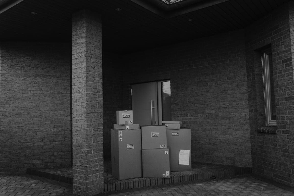 Delivery boxes stacked by an office doorway ready to be unpacked by staff